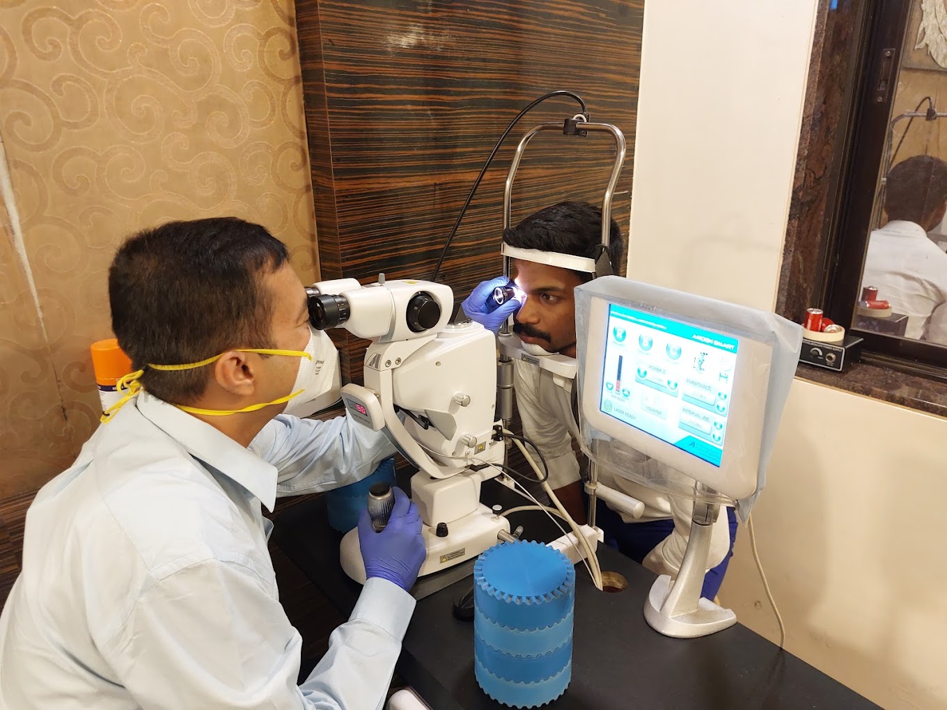Dr. Sachin Tiwari performing ophthalmic laser / slit-lamp procedure at the clinic